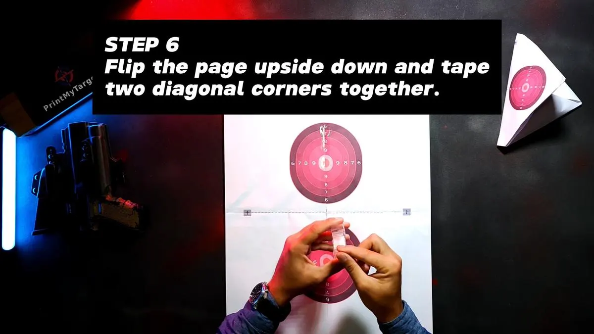 Step 6 - Flip the page upside down and tape two diagonal corners together.